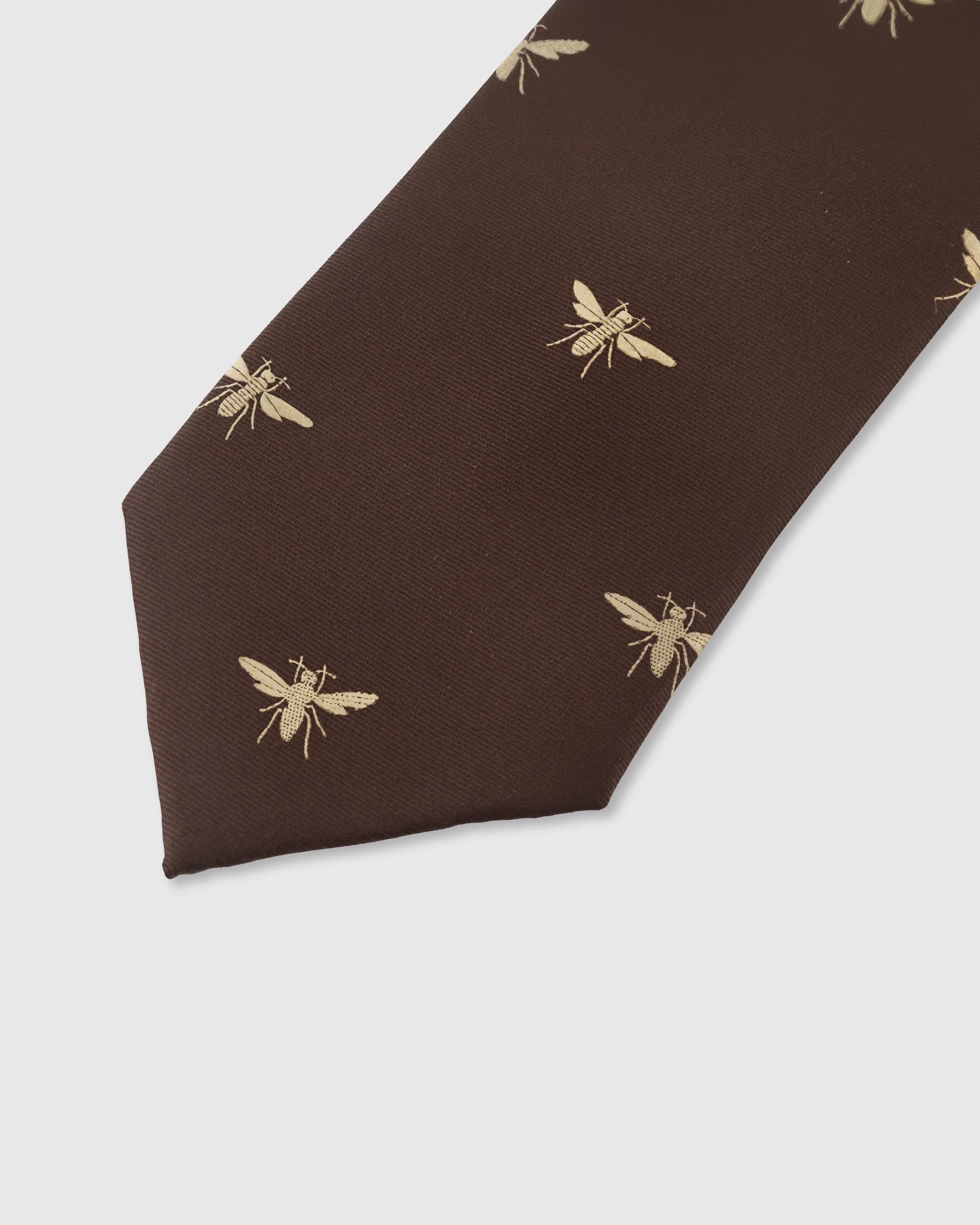 Gold bee motif detail on cocoa mulberry silk tie showing raised hand-embroidered wings and body by STICKYZOO
