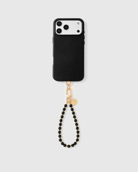 Full phone with black bead strap attached on light grey background