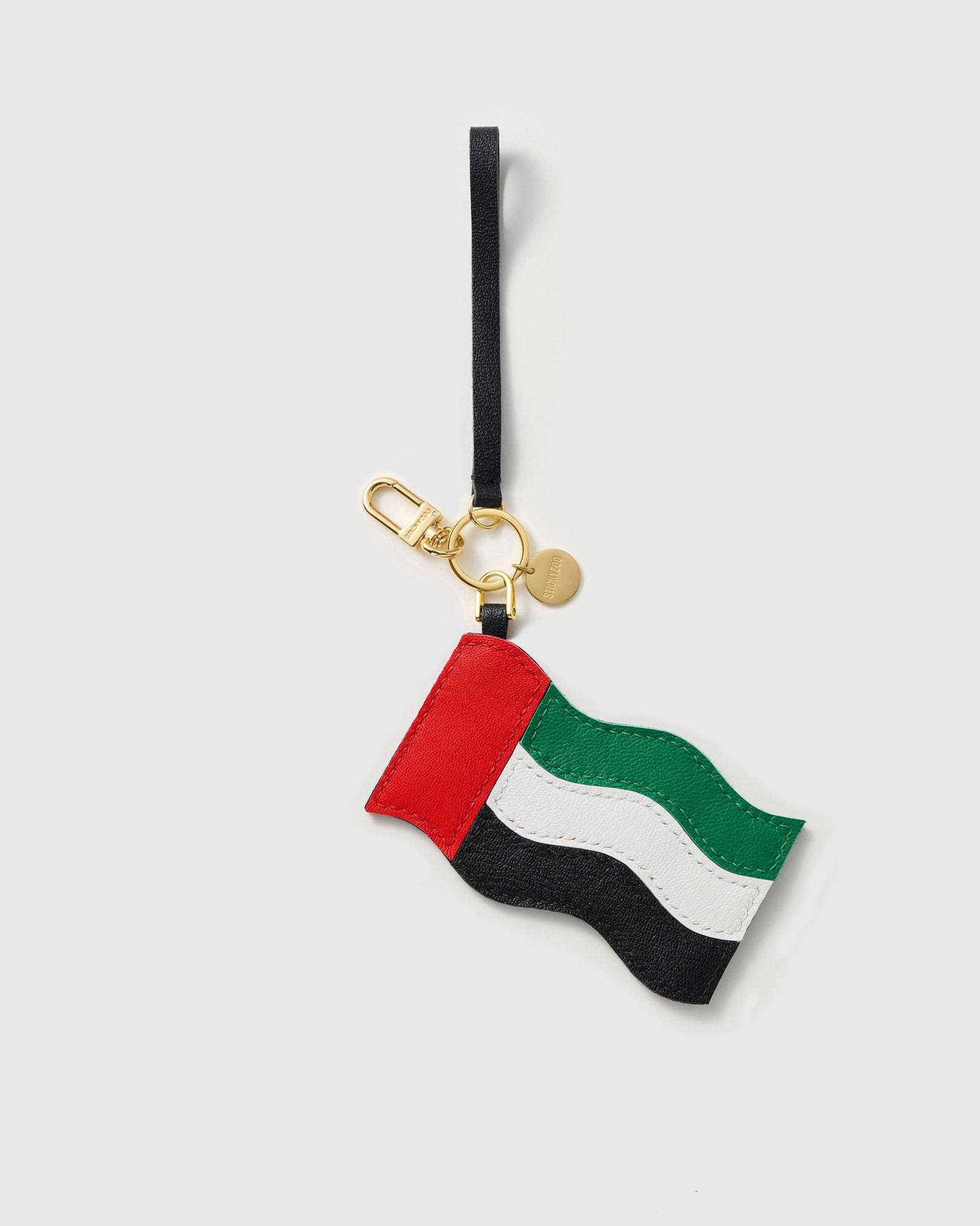 UAE flag charm with gold keychain clasp, split ring, engraved STICKYZOO coin, and leather wrist strap