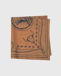 Folded western silk scarf showing the longhorn skull and rope details printed in archival navy ink