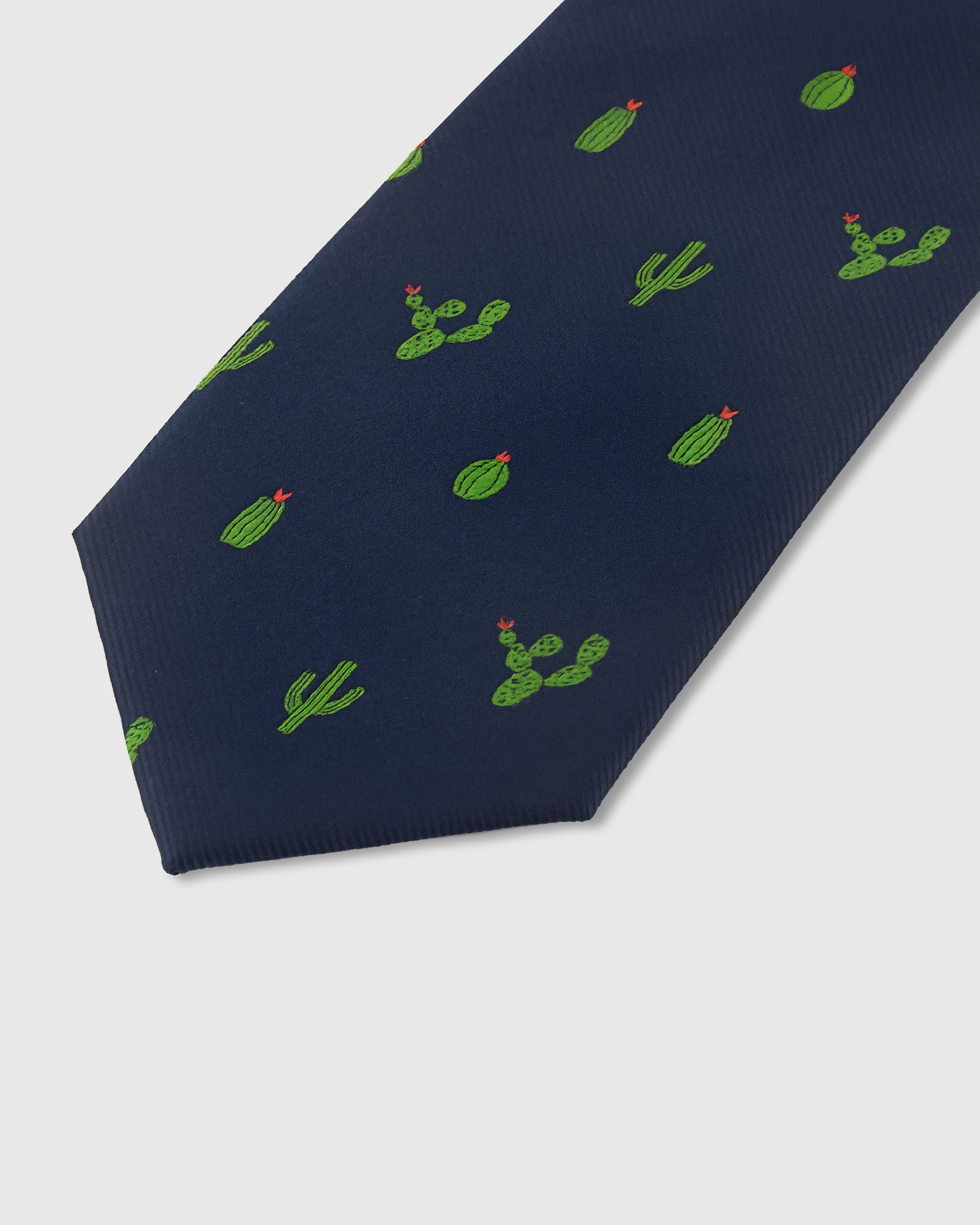 Green cactus motif detail on navy mulberry silk tie showing raised hand-embroidered stems and blooms by STICKYZOO