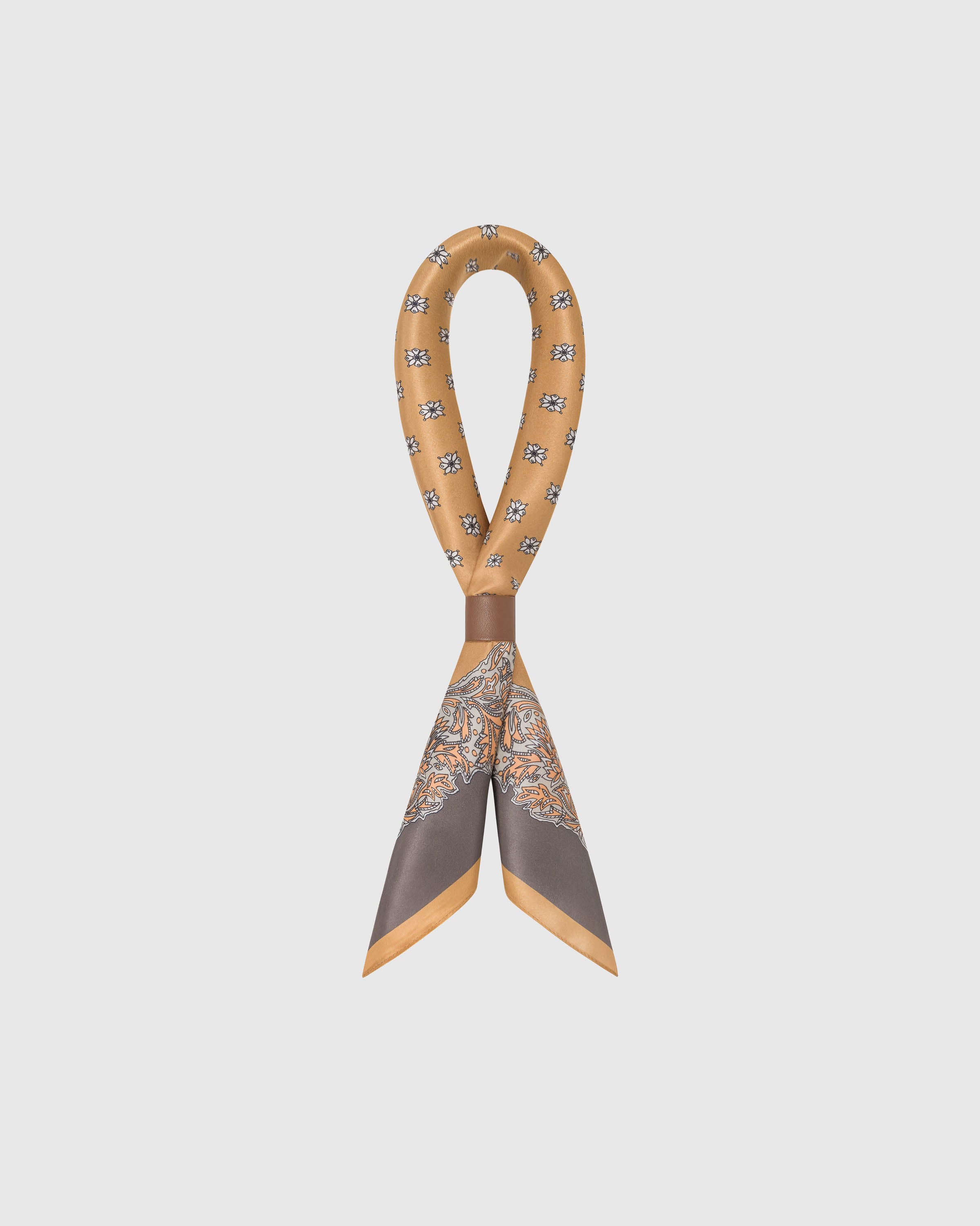 STICKYZOO amber foulard silk scarf looped through a leather ring showing how the printed silk falls