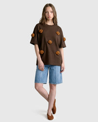 Model in brown Poodle Parade T-Shirt with relaxed silhouette showing tonal plush contrast