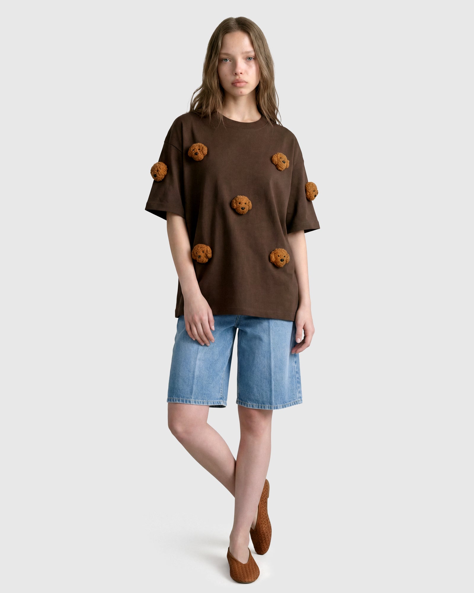 Model in brown Poodle Parade T-Shirt with relaxed silhouette showing tonal plush contrast