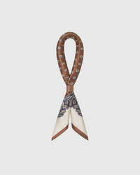 STICKYZOO chestnut baroque silk scarf looped through a leather ring showing the printed silk drape