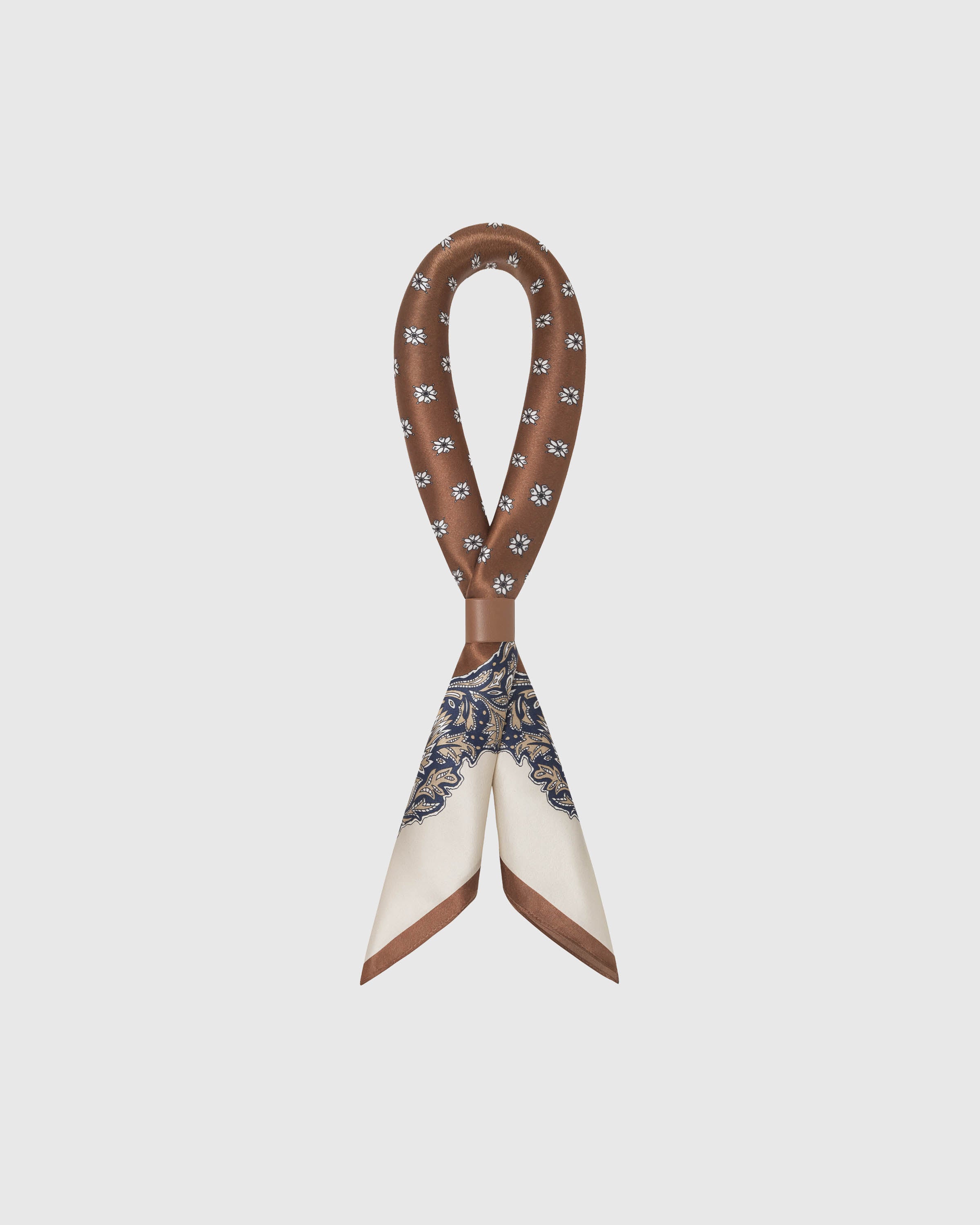 STICKYZOO chestnut baroque silk scarf looped through a leather ring showing the printed silk drape