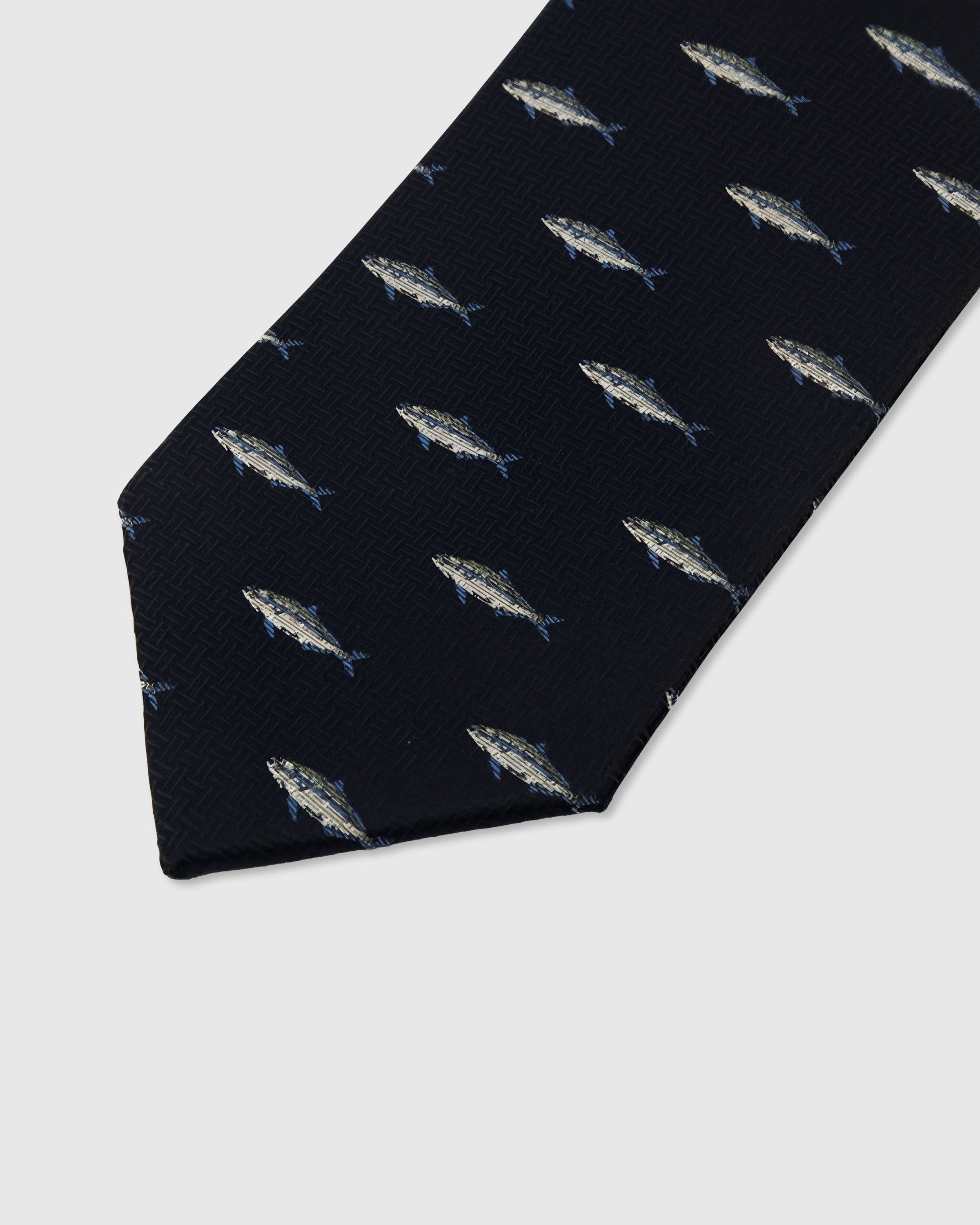 Silver trout motif detail on midnight mulberry silk tie showing raised hand-embroidered thread by STICKYZOO