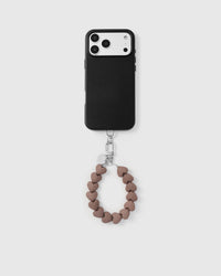 Mocha heart bead phone strap hanging from black phone case showing full pairing