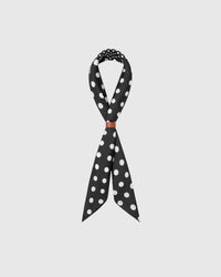 STICKYZOO noir polka silk scarf looped with a leather wrap showing how the dot quadrants meet across the knot