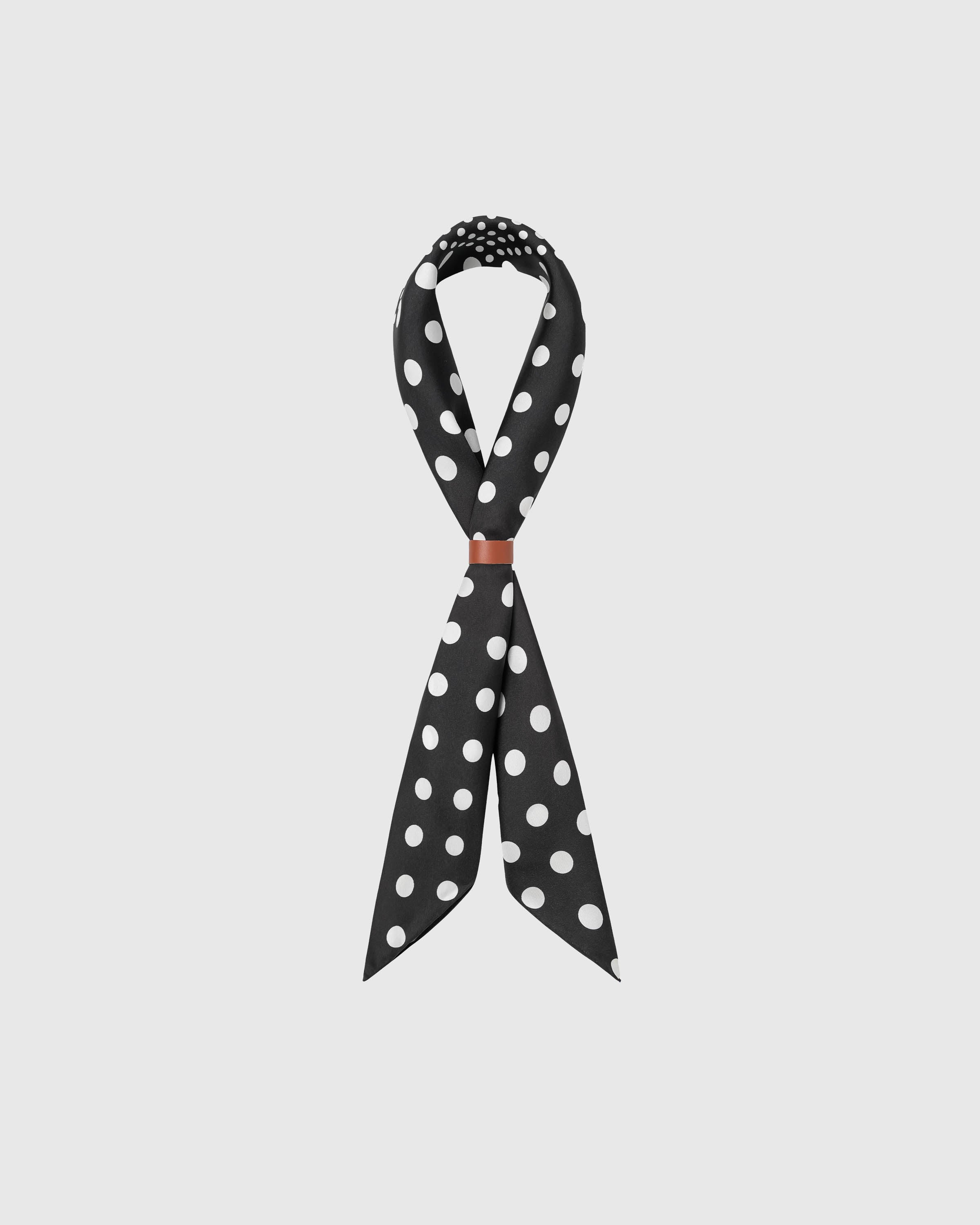 STICKYZOO noir polka silk scarf looped with a leather wrap showing how the dot quadrants meet across the knot