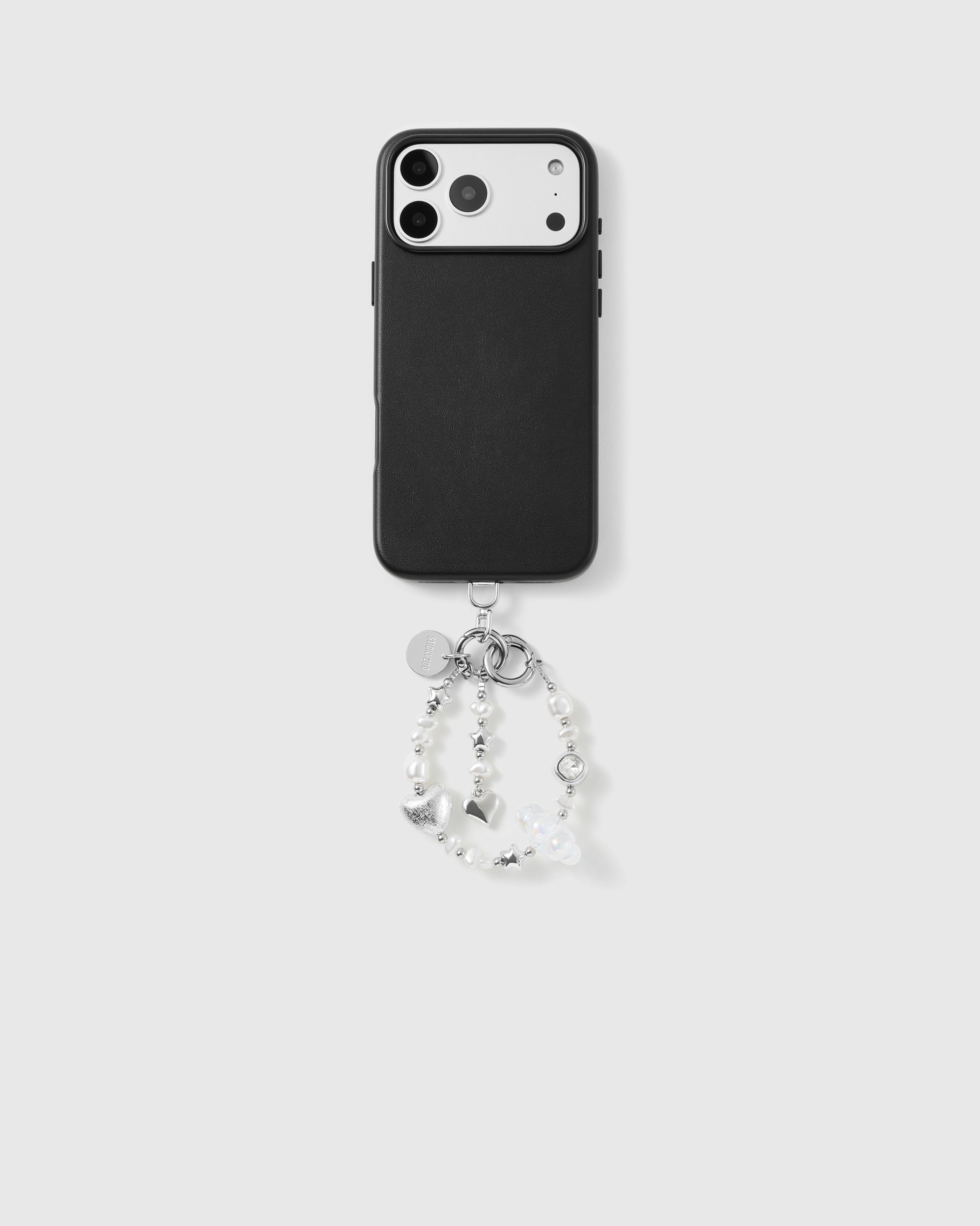Black phone case with the pearl-and-silver beaded wrist strap looped below, silver-tone stars, hearts and engraved STICKYZOO disc