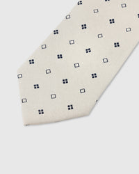 Navy square dot detail on pearl mulberry silk tie showing raised hand-embroidered geometric motifs by STICKYZOO