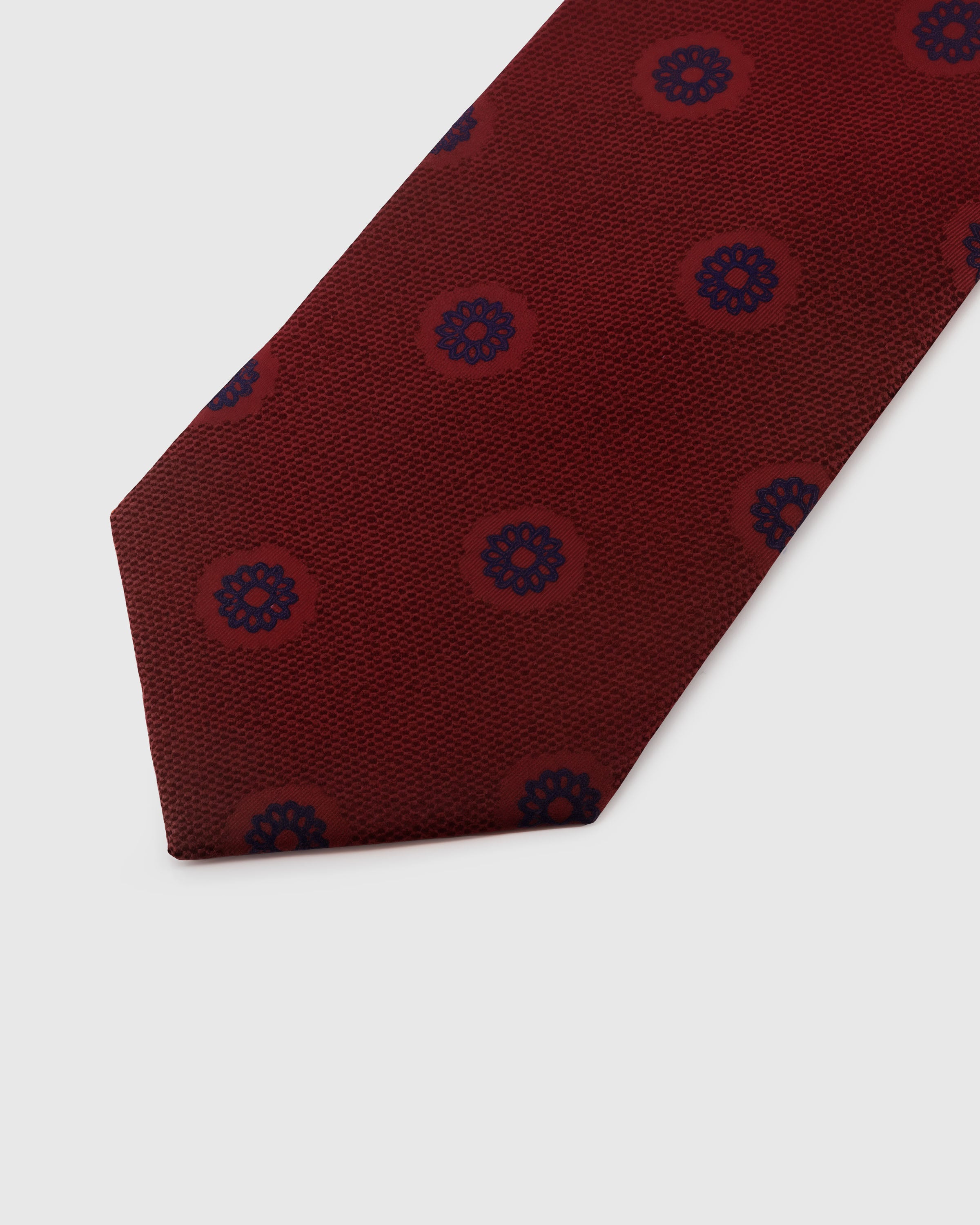 {{Embroidered, not printed}} Navy rosette medallion detail on burgundy mulberry silk tie showing raised hand-embroidered thread by STICKYZOO