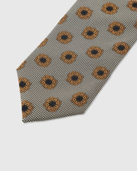 Amber rosette medallion detail on pewter houndstooth mulberry silk tie showing raised hand-embroidered thread by STICKYZOO