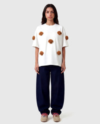 Model in white Poodle Parade T-Shirt angled pose showing plush poodle appliques
