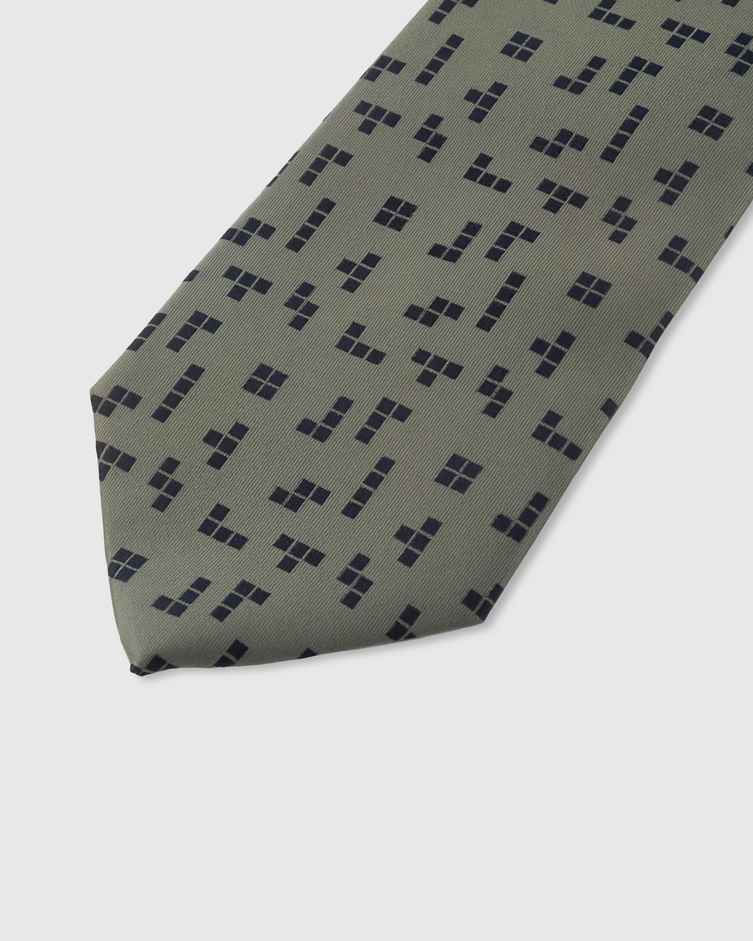 Navy geometric square cluster detail on sage mulberry silk tie showing raised hand-embroidered motifs by STICKYZOO
