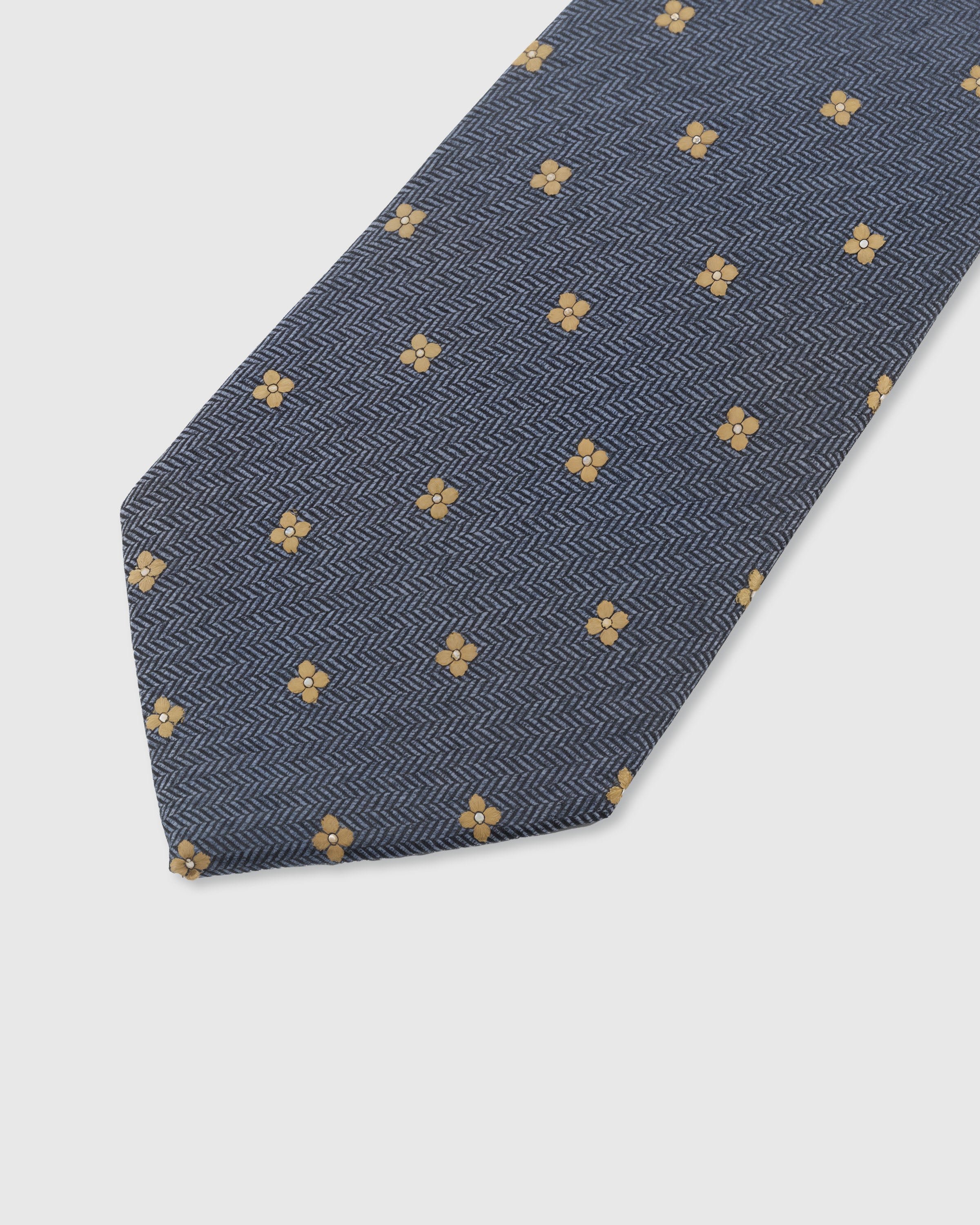 {Embroidered gold clover dot detail} Herringbone detail on slate blue mulberry silk tie showing embroidered pattern by STICKYZOO