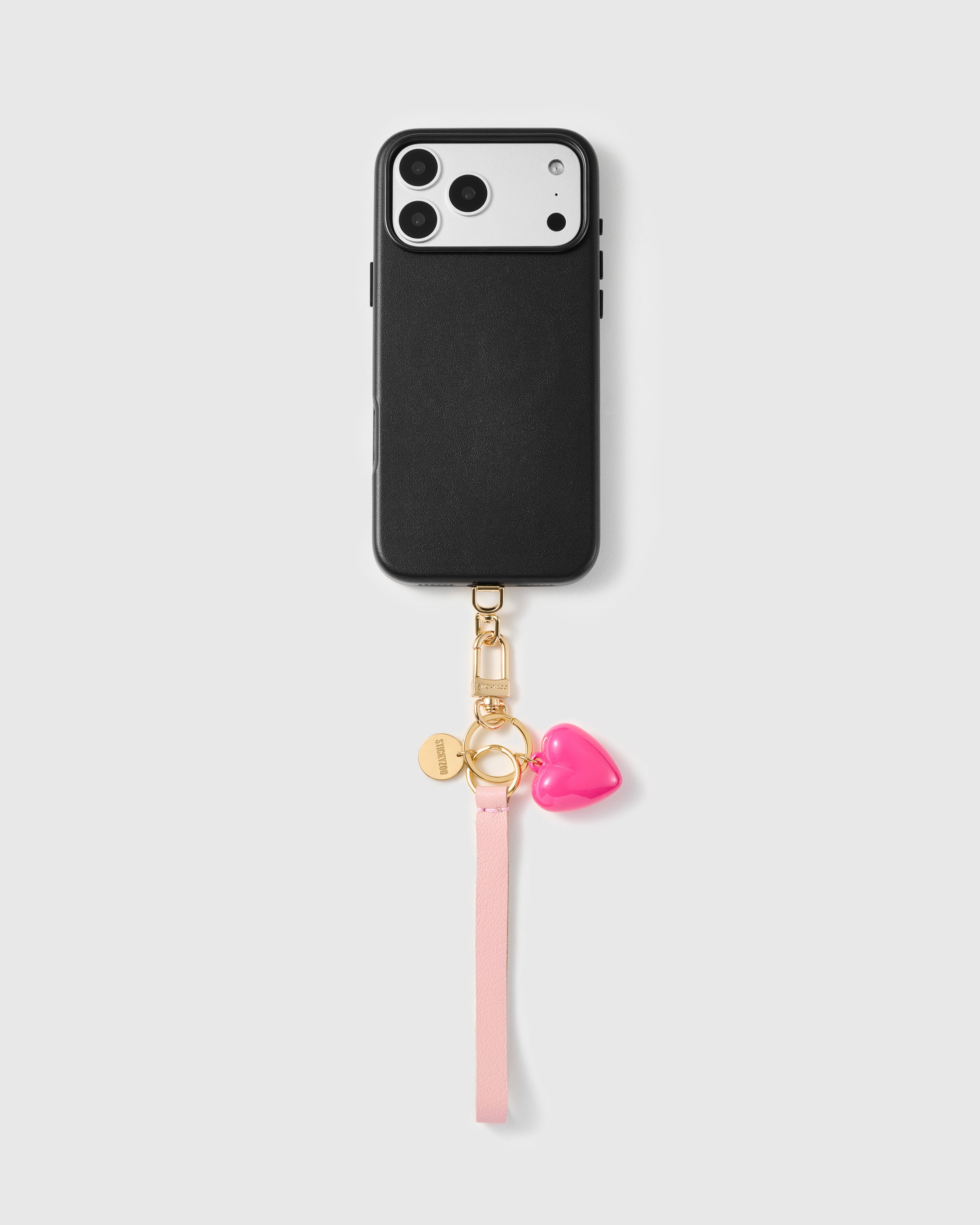 Close-up of pebbled pale pink French Alran leather phone strap edge with engraved gold STICKYZOO hardware