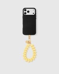 Lemon heart phone strap attached to black phone case showing universal compatibility