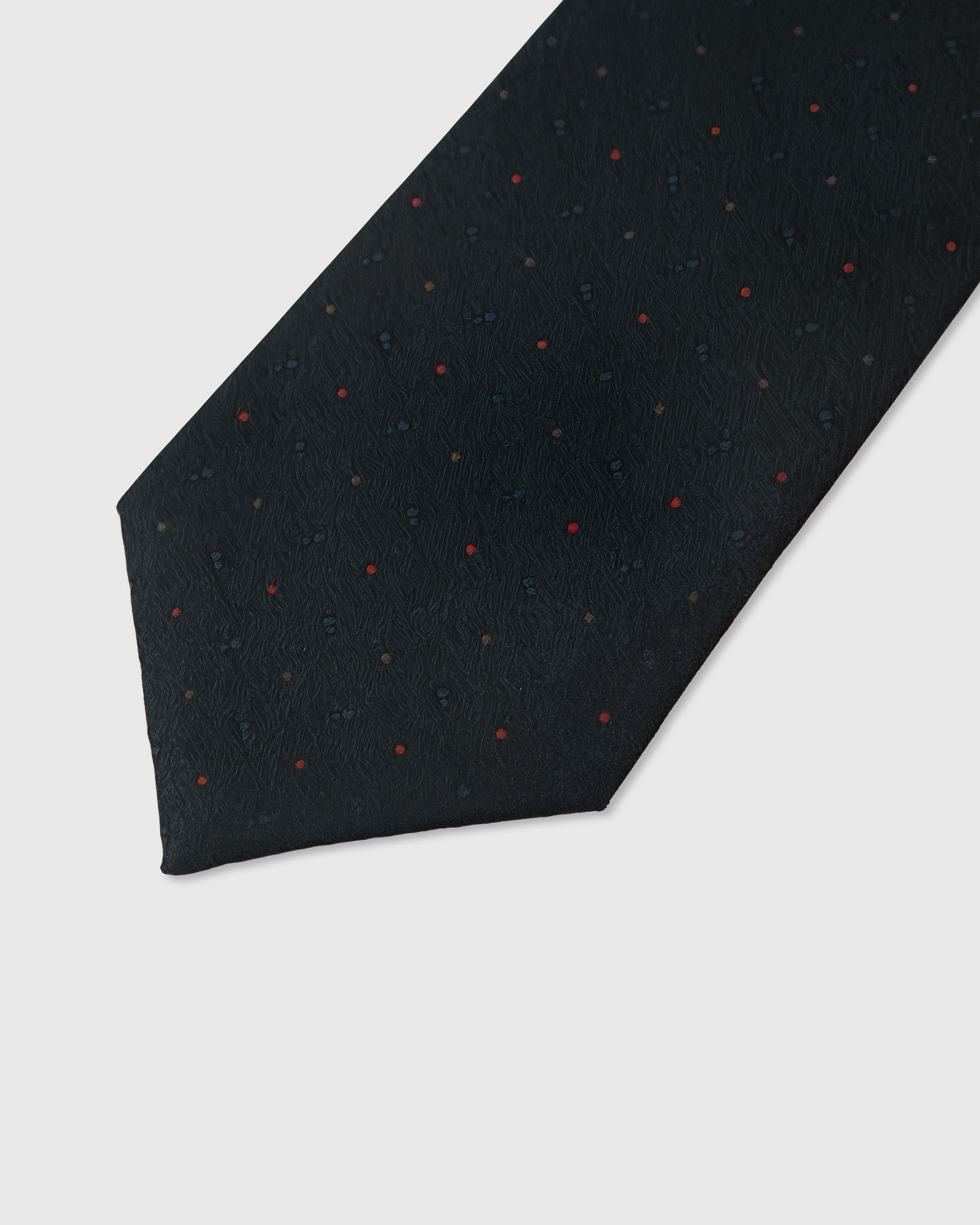 Crimson speckle dot detail on obsidian mulberry silk tie showing raised hand-embroidered thread by STICKYZOO