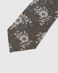 UMBER FLORAL TIE — 45° Italian bias-cut construction with structured interlining, hand-finished slip stitching visible on interior