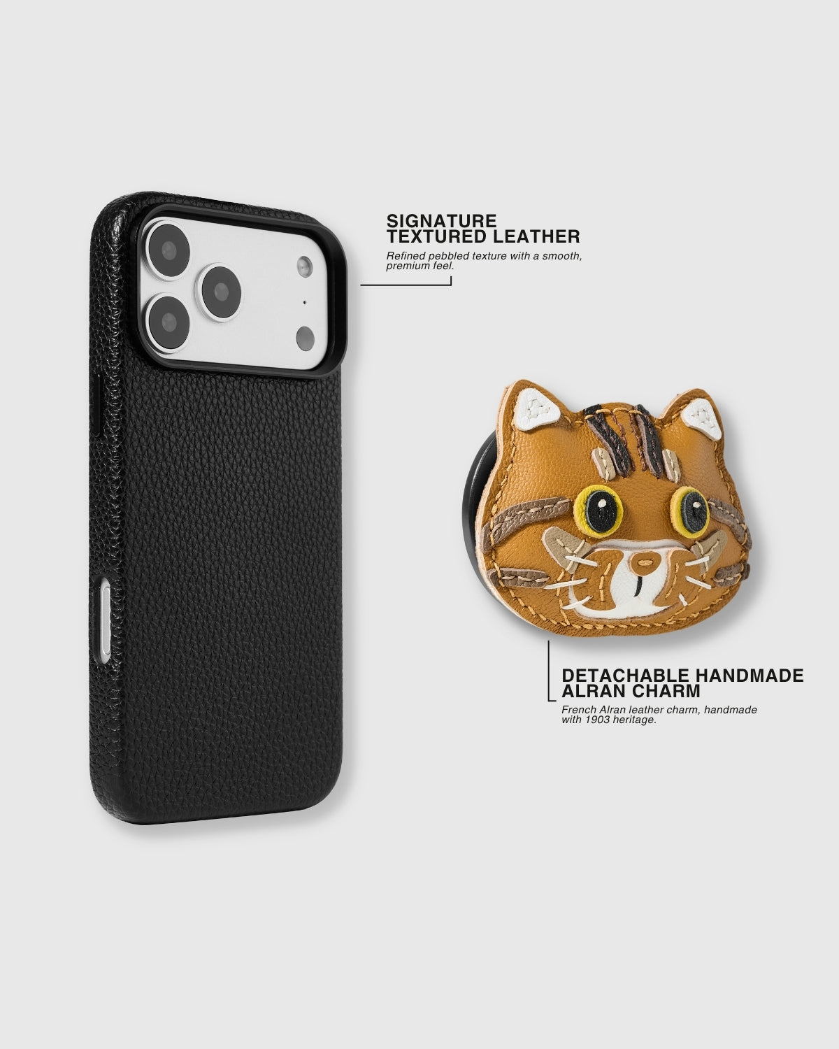 {{Case and charm, separated.}} Black textured leather case and detachable handmade French Alran leather ginger tabby cat charm shown separately — signature pebbled leather and magnetic MagSafe-compatible charm grip. Rated 4.9 stars.