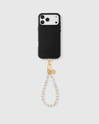 Ivory marble stone strap attached to black phone case showing universal fit
