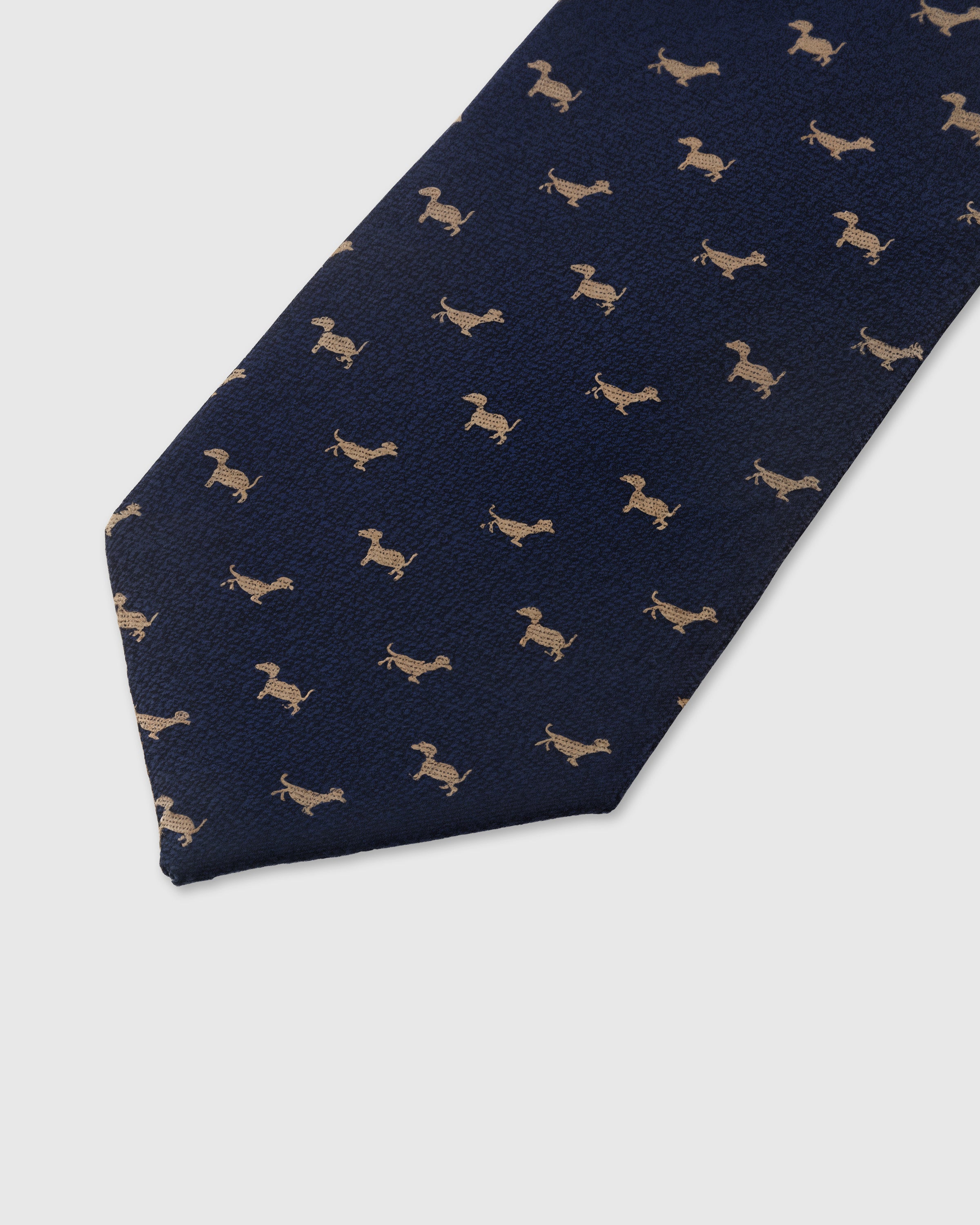 Gold dachshund motif detail on navy mulberry silk tie showing raised hand-embroidered thread by STICKYZOO