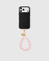 Full phone with rose agate bead strap attached on light grey background