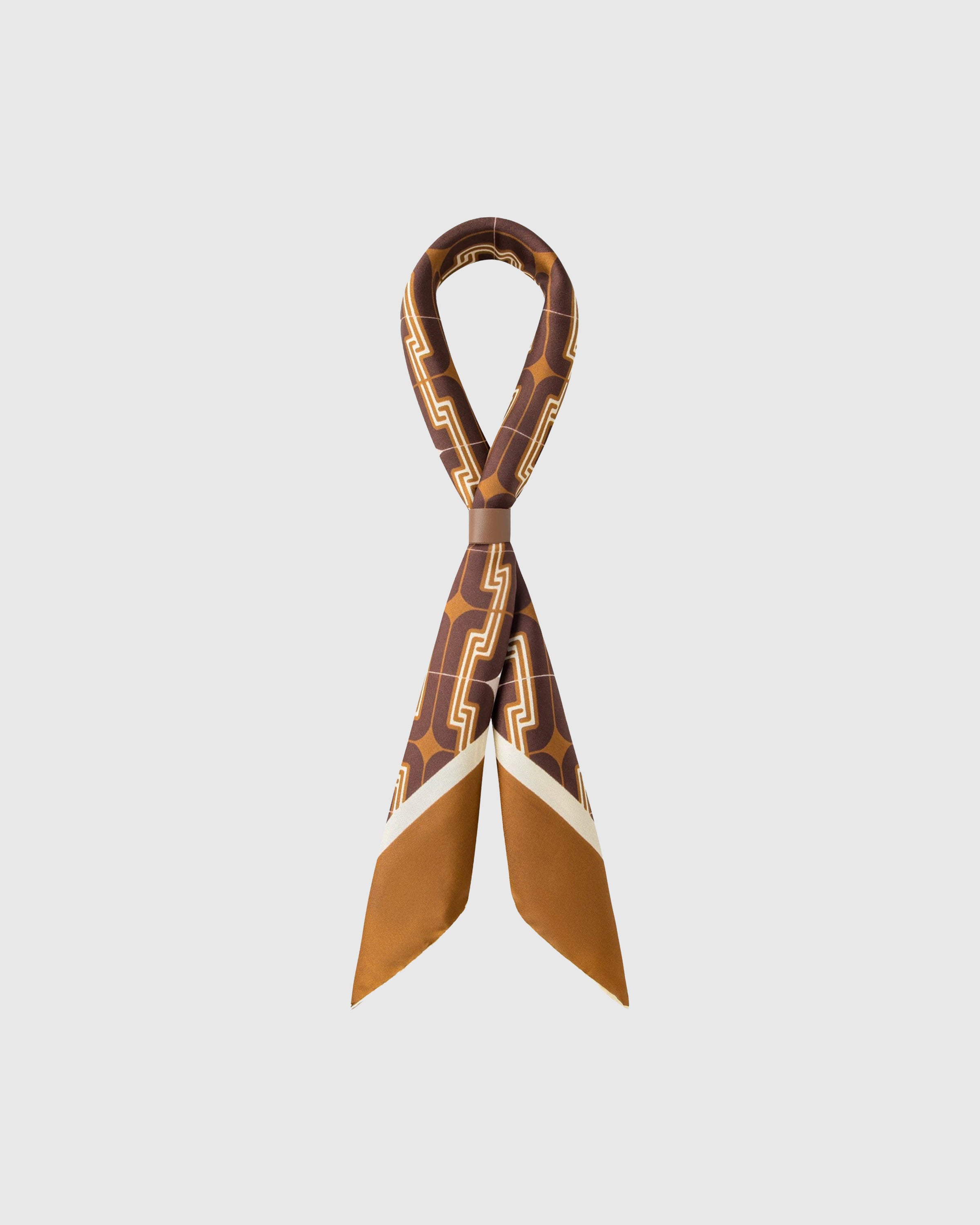 STICKYZOO tobacco deco silk scarf looped through a leather slide showing the chain motif on oxblood
