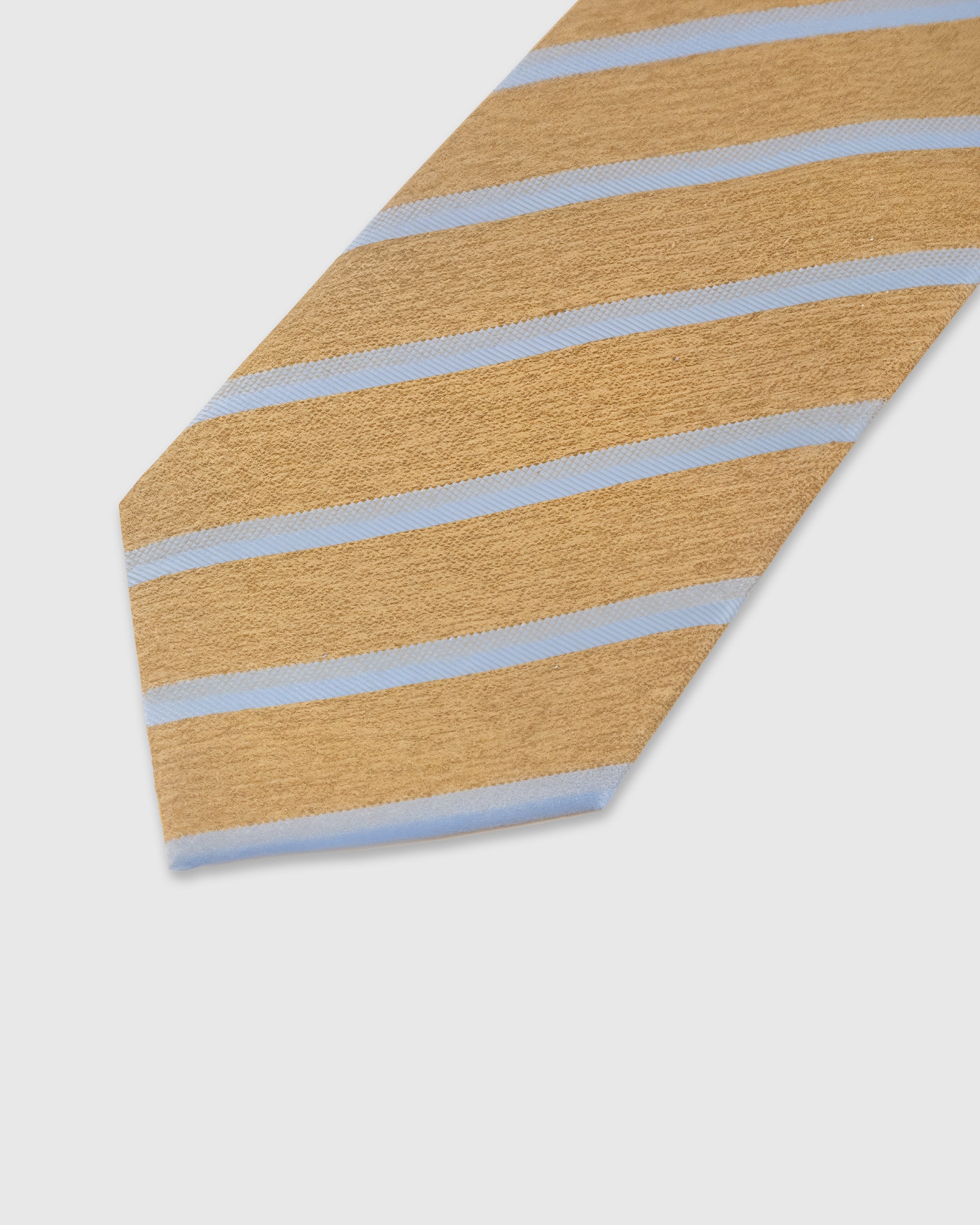 Sky blue diagonal stripe detail on camel mulberry silk tie showing raised hand-embroidered thread on textured ground by STICKYZOO