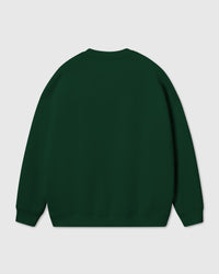 Model wearing Poodle Parade Sweatshirt in forest green showing oversized boxy proportions