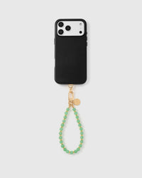 Full phone with sage orbit stone bead strap attached on light grey background