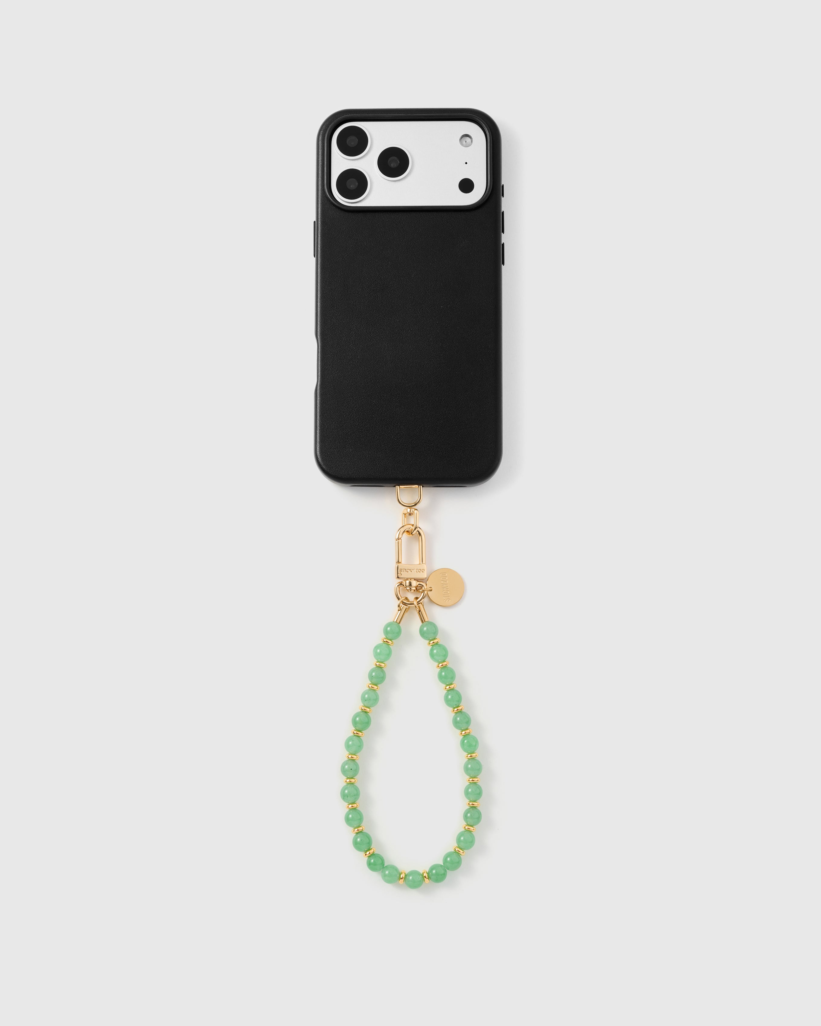 Full phone with sage orbit stone bead strap attached on light grey background