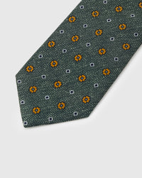 Amber floret motif on sage herringbone mulberry silk tie showing hand-embroidered four-petal flower by STICKYZOO