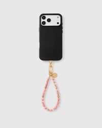 Full phone with cotton candy bloom strap attached on grey background