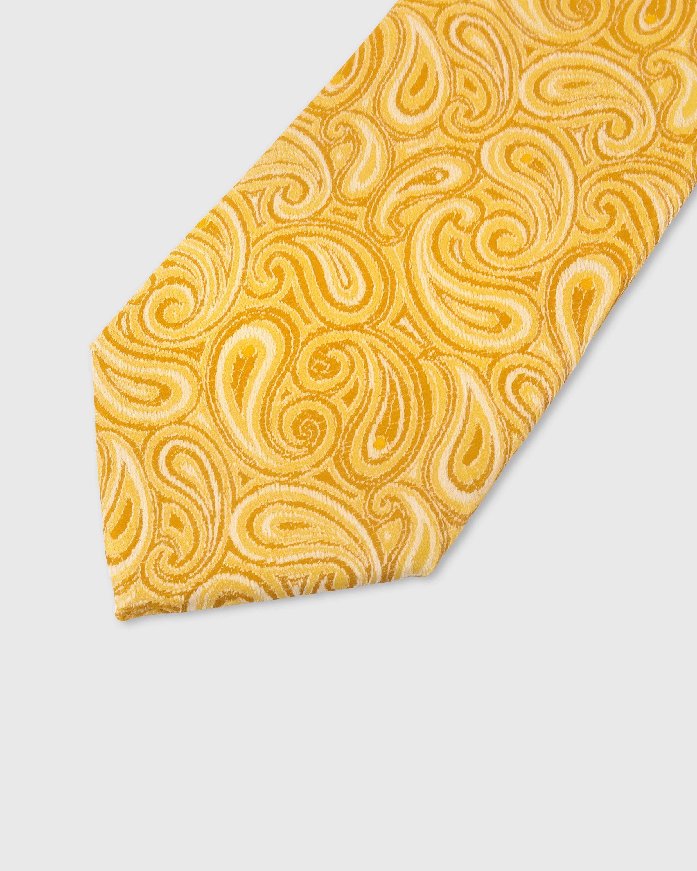 SAFFRON PAISLEY TIE — 45° Italian bias-cut construction with structured interlining, hand-finished slip stitching visible on interior