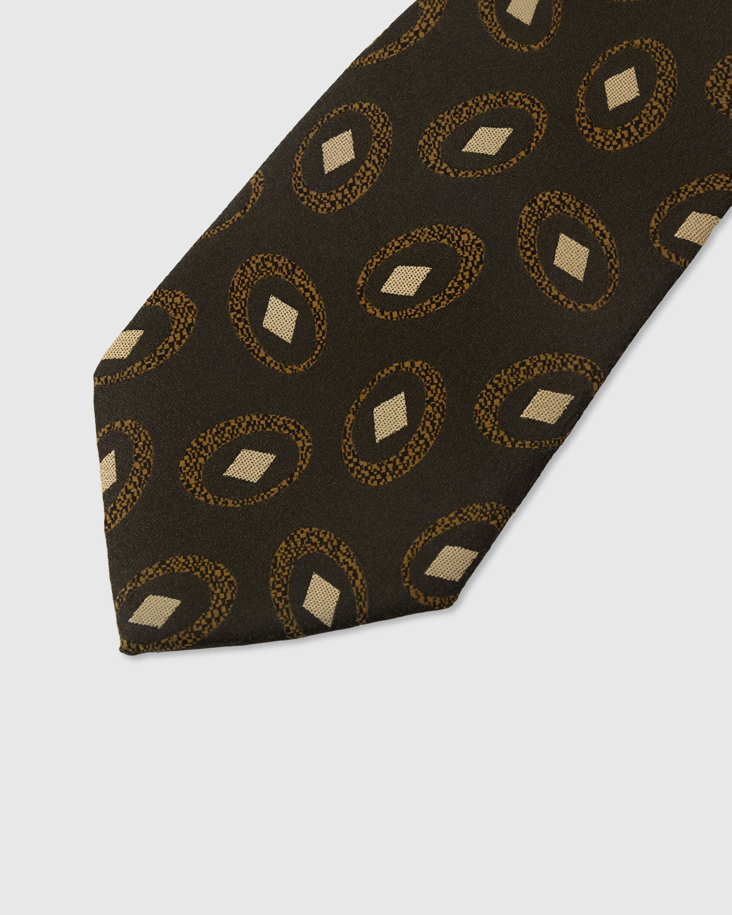 Gold medallion circle detail on umber mulberry silk tie showing raised hand-embroidered thread by STICKYZOO