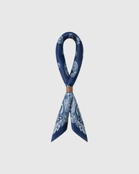 STICKYZOO porcelain paisley silk scarf looped through a leather cuff showing the navy print