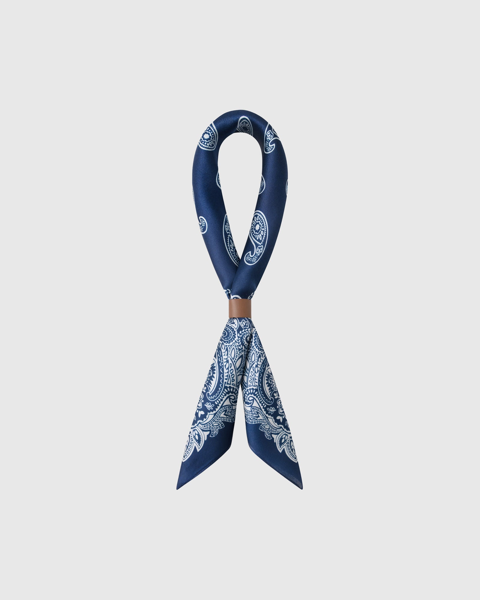 STICKYZOO porcelain paisley silk scarf looped through a leather cuff showing the navy print