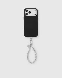 Chrome sphere phone strap attached to black phone case showing universal fit