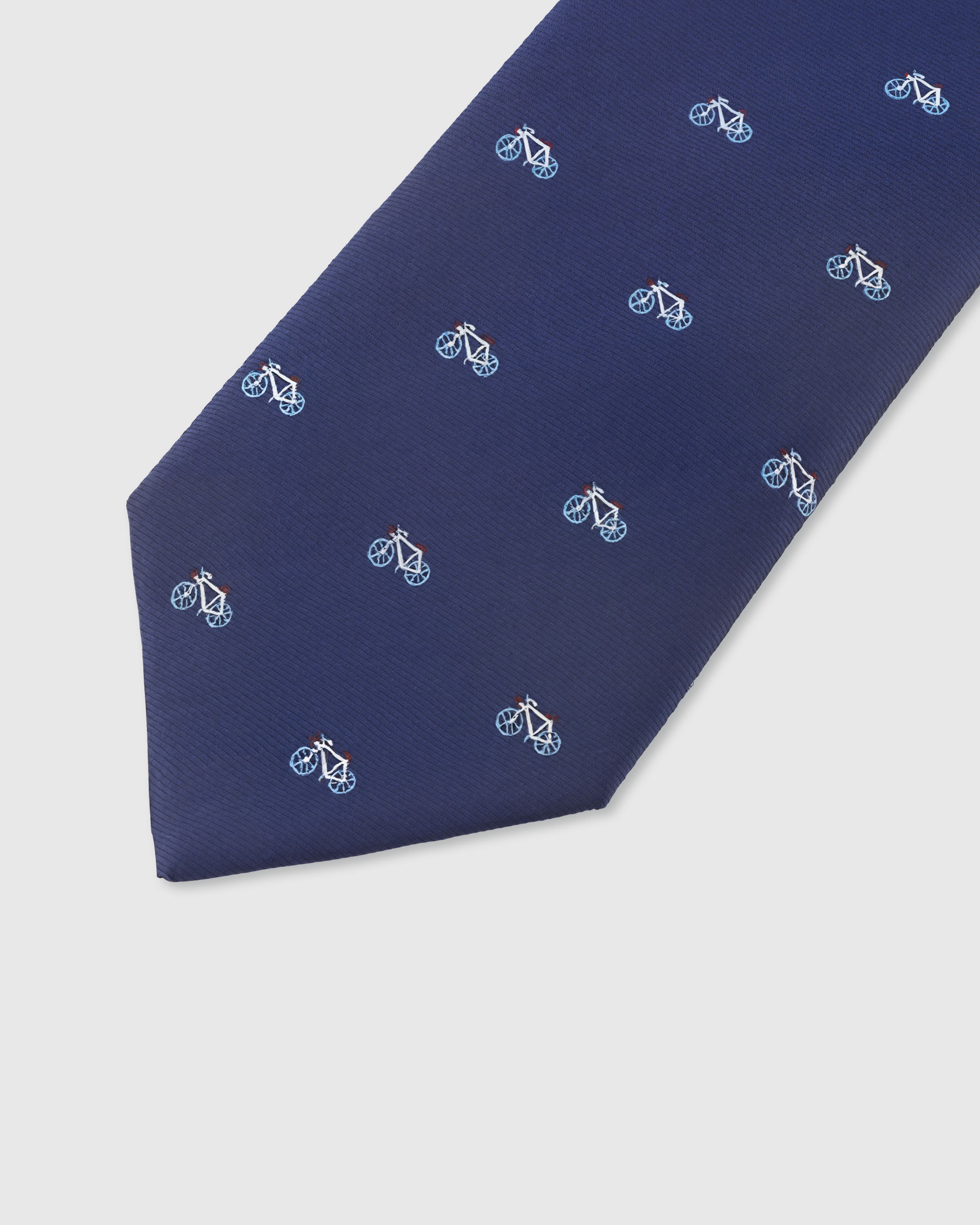 NAVY BICYCLE TIE — 45° Italian bias-cut construction with structured interlining, hand-finished slip stitching visible on interior