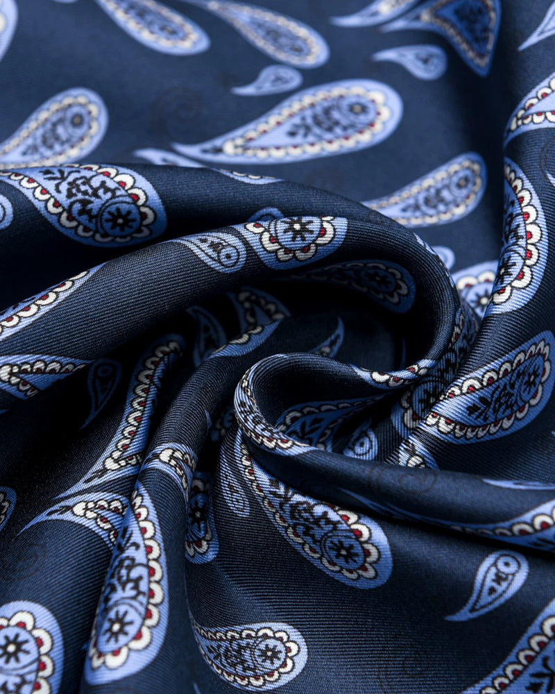 Close-up of the navy silk swirled to show the boteh paisley print and the soft silk drape