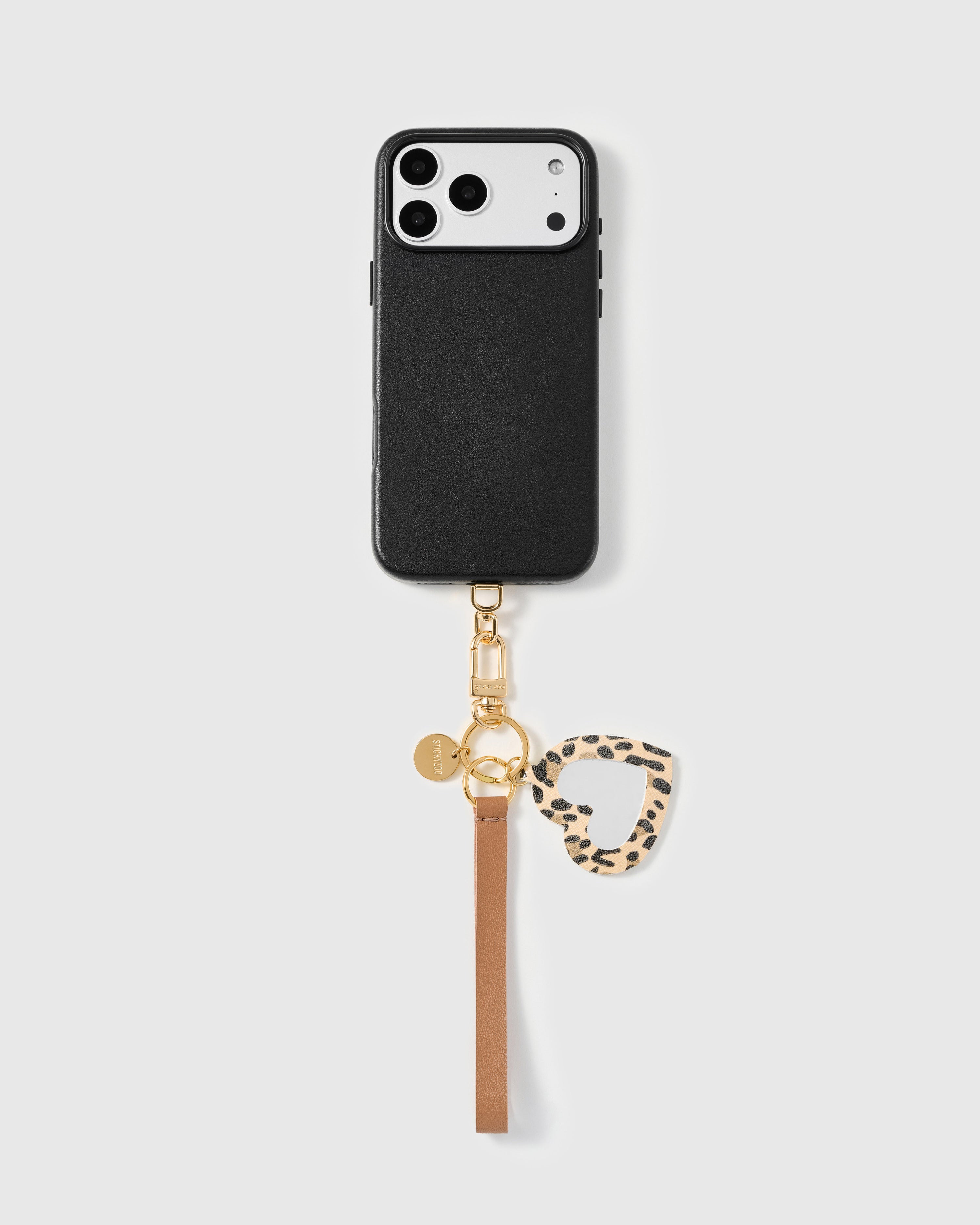 Close-up of leopard heart mirror charm showing hand-stitched calf hair frame and real glass