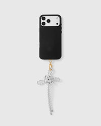 Pearl bow phone strap attached to black phone case showing universal clip-on compatibility
