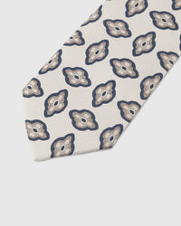 Amoeba medallion detail on pearl mulberry silk tie showing hand-embroidered organic motif by STICKYZOO
