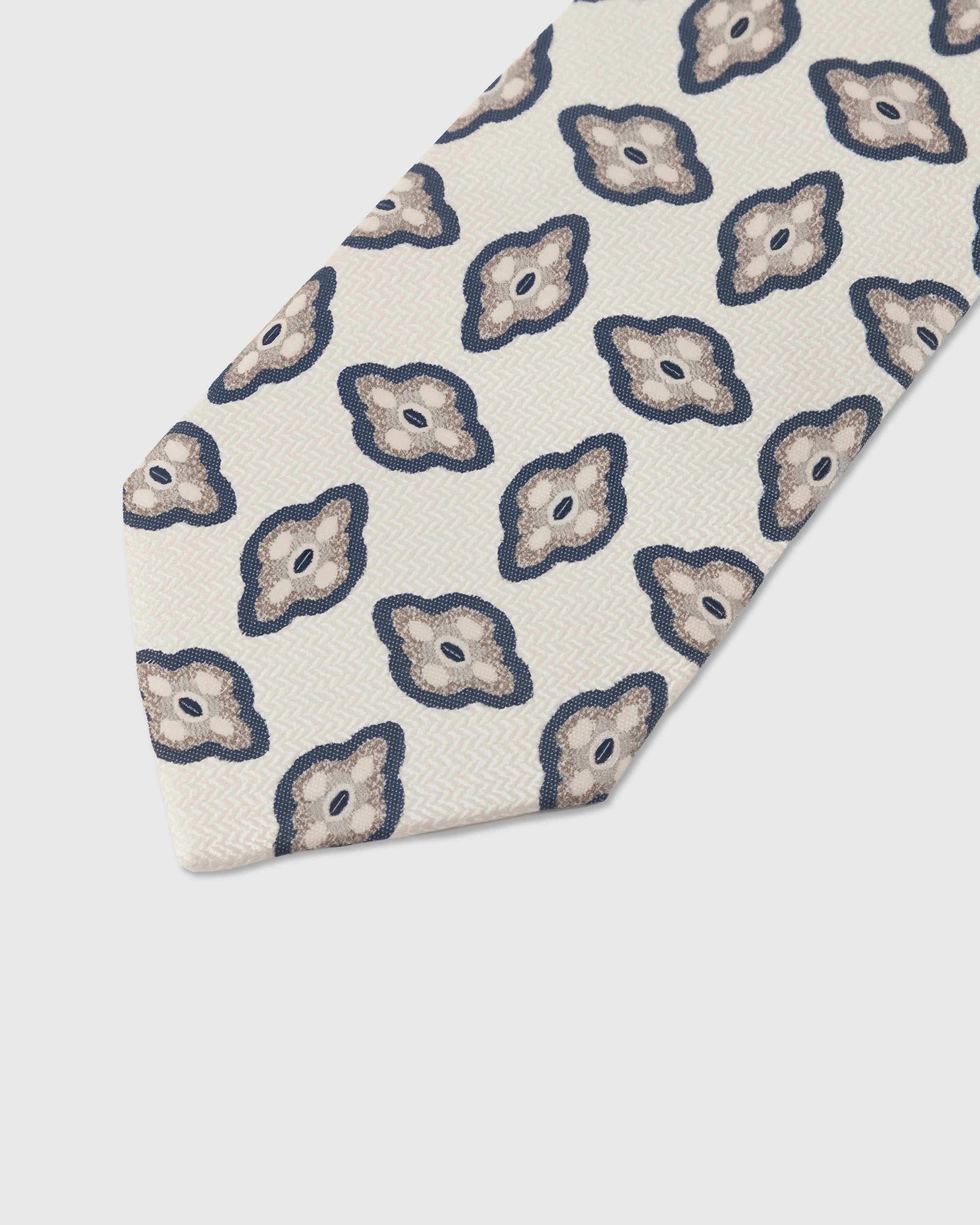 Amoeba medallion detail on pearl mulberry silk tie showing hand-embroidered organic motif by STICKYZOO