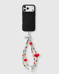 Full phone with triple heart multi-strand strap attached on grey background