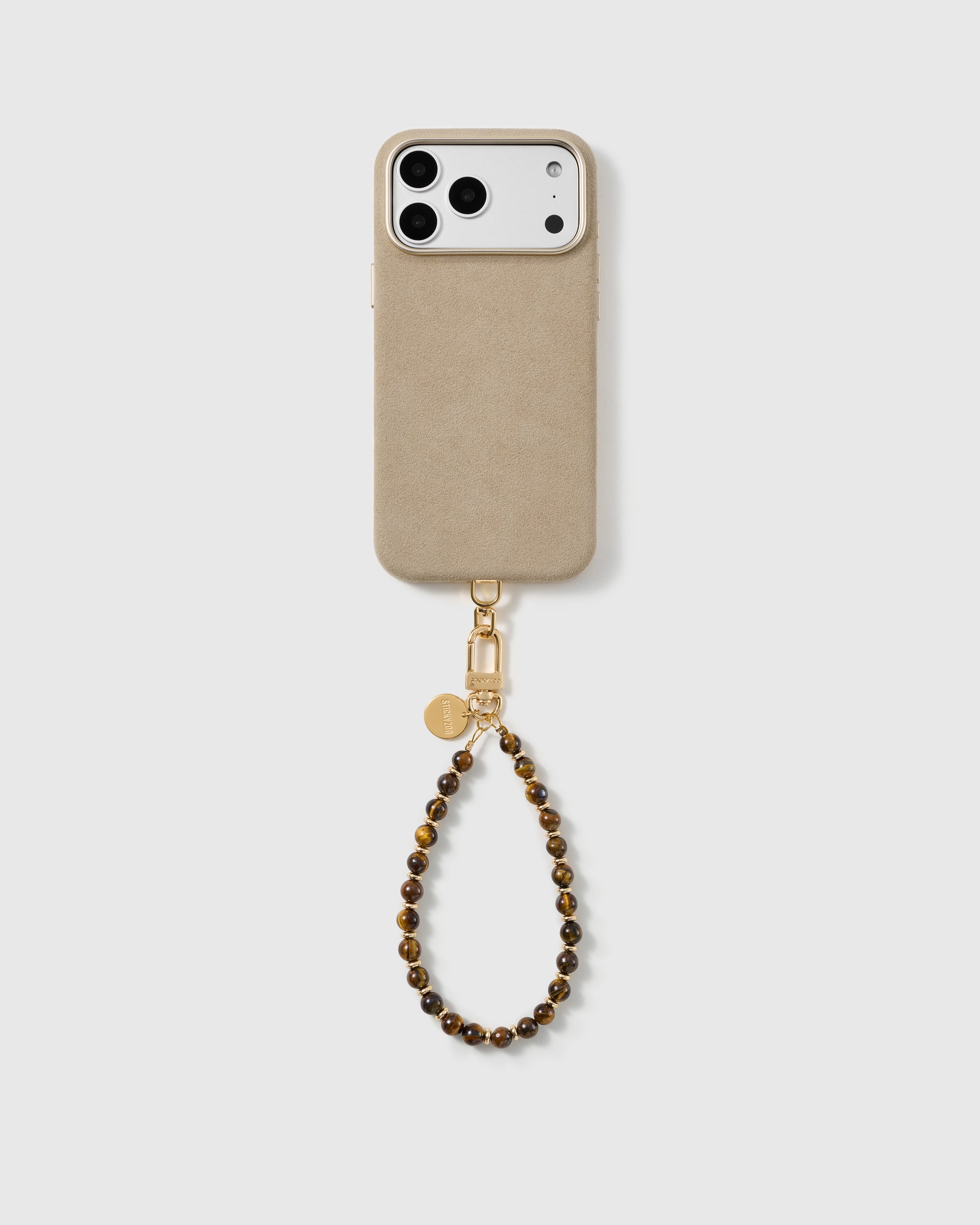 Full phone fitted with the STICKYZOO bronze stone wrist strap in a studio shot