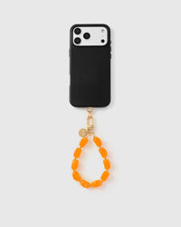 Full phone with amber agate stone strap attached on grey background